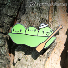 Peater at Sea enamel pin stuck to a tree, which is not the recommended way to wear them