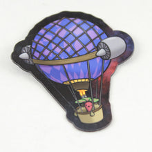 A magnet showing a beet manning a hot air balloon outfitted with a poorly thought out pair of jet engines attached